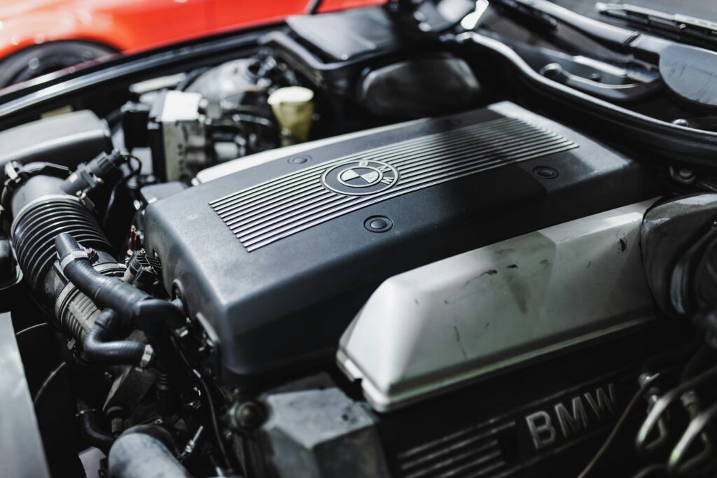 Detailed view of a BMW engine under the hood, showcasing automotive engineering.